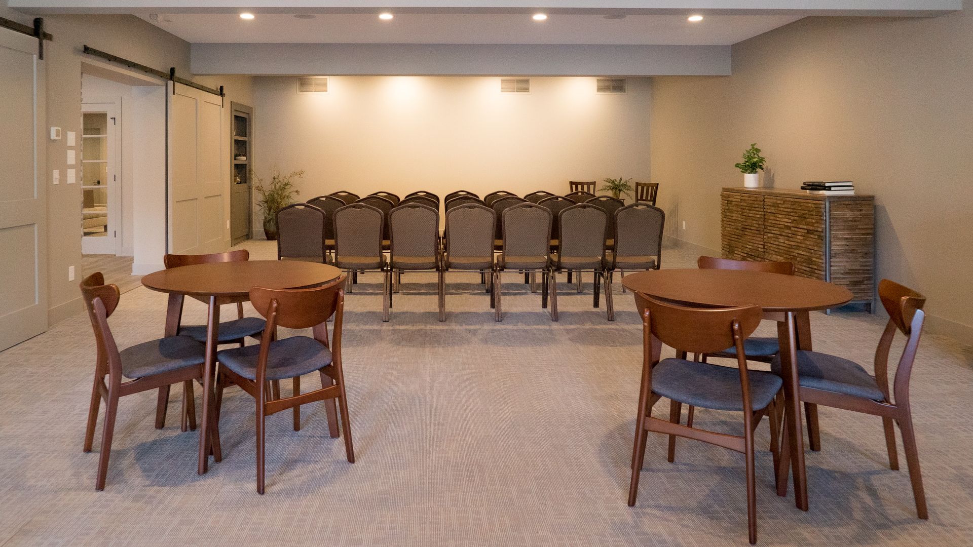 A large room with tables and chairs in it.