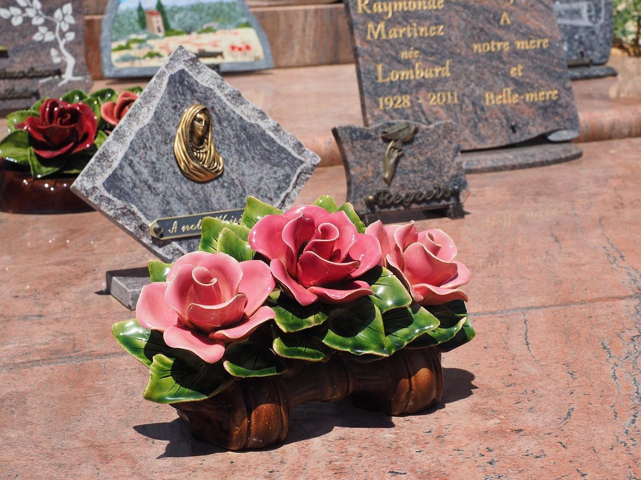 Family grave site with memorial stones in a peaceful cemetery setting