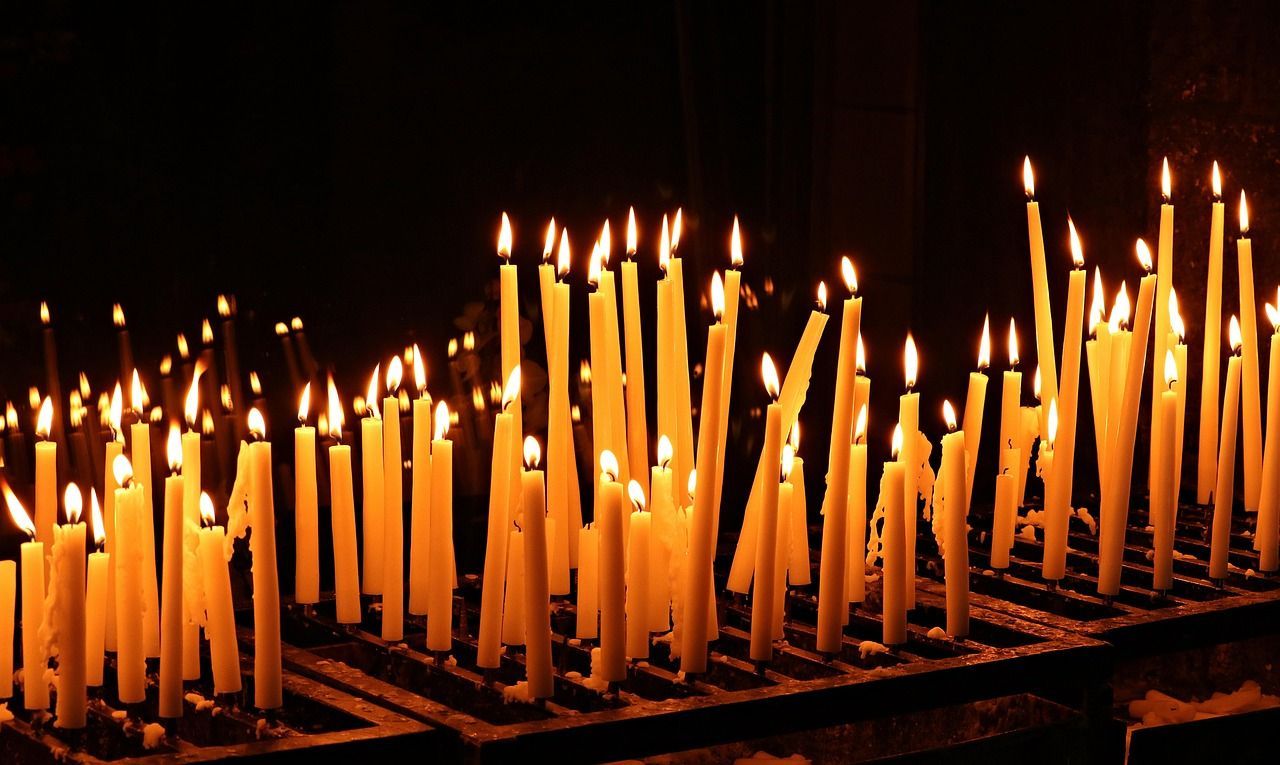 Lit candles arranged for prayer, worship, and remembrance