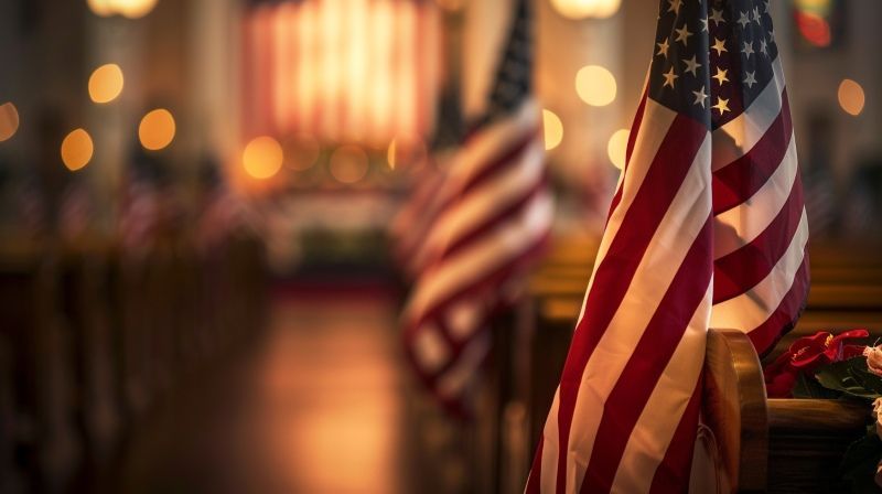 U.S. flags lining a softly lit chapel aisle during a memorial service, supporting Shakopee, MN veteran services with honor.