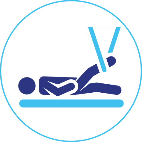 A person is laying on a bed with a pair of scissors.