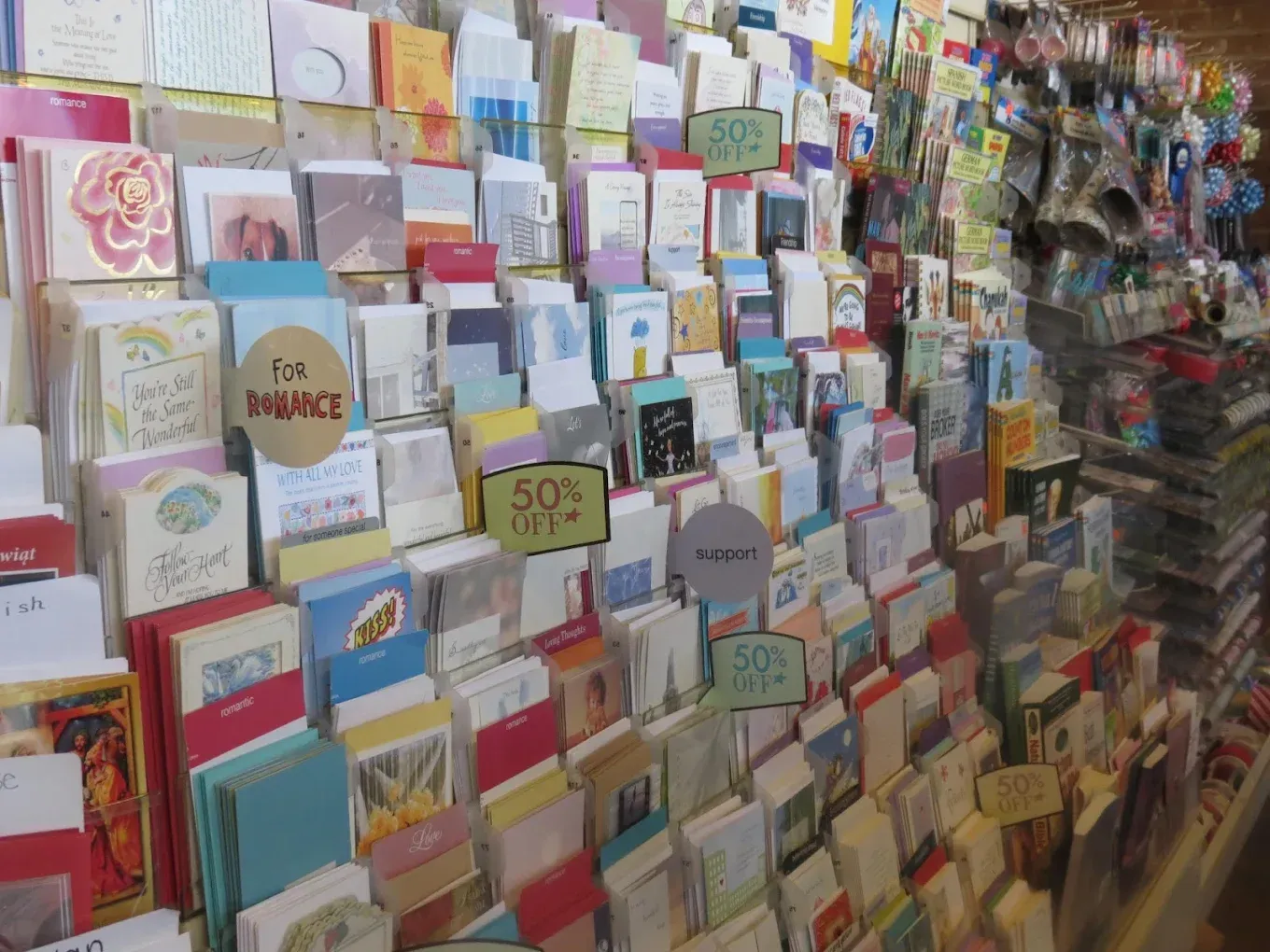 A display of greeting cards for sale in a store, with various designs and colors visible.