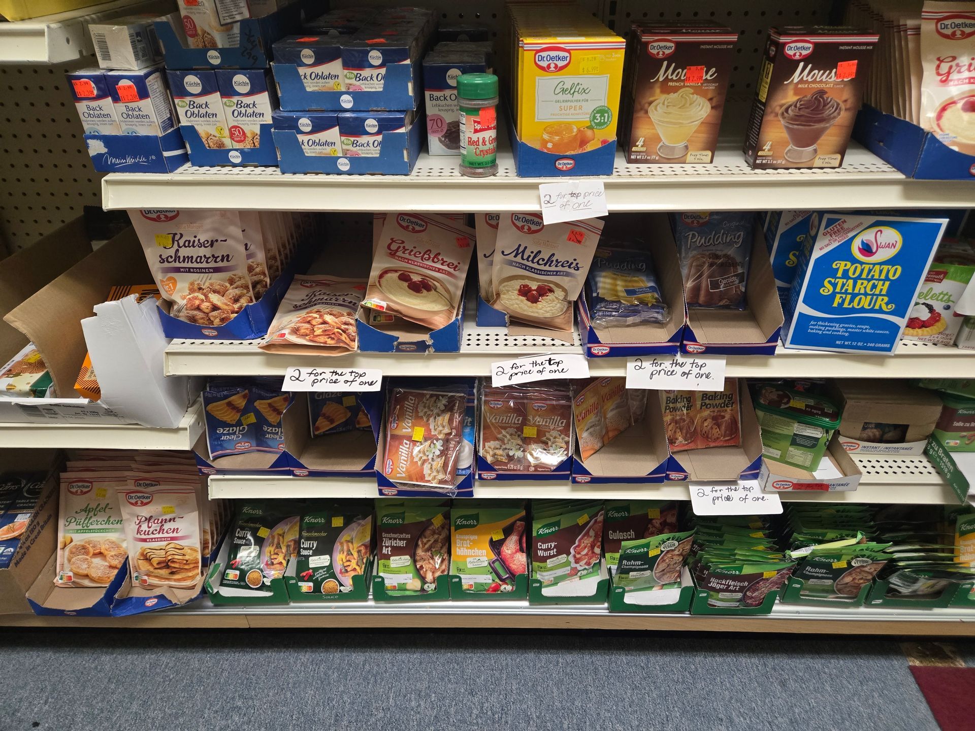 Assortment of store items: chocolates, stuffed animals, exercise equipment, and various packaged goods.
