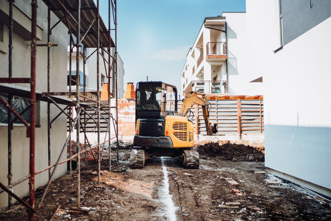 Excavator Digging a Trench at A Construction Site — Bigfoot Earthmoving In Lennox Head, NSW