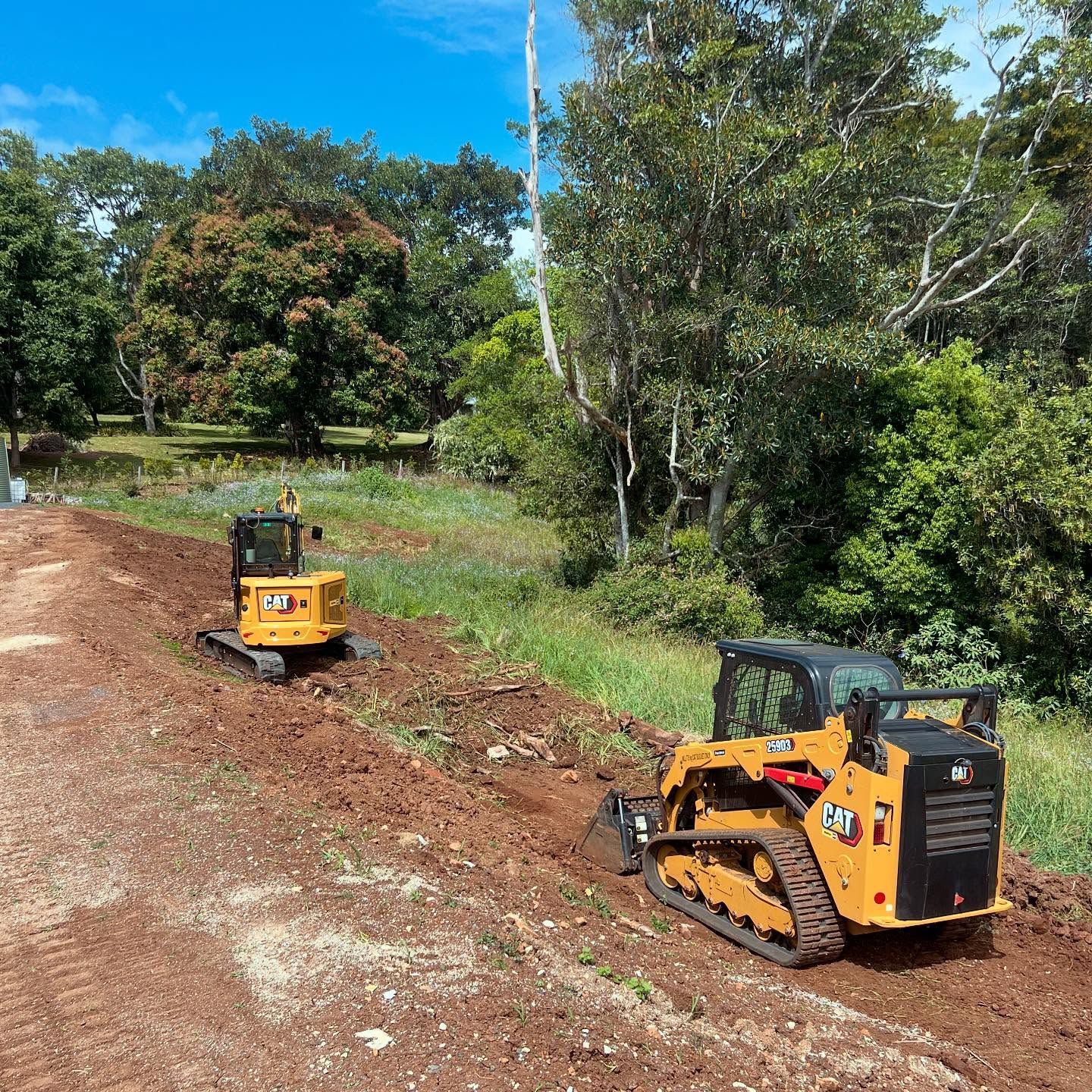 Two Yellow Caterpillar Construction Vehicles on A Dirt Path  — Bigfoot Earthmoving In Byron Bay, NSW