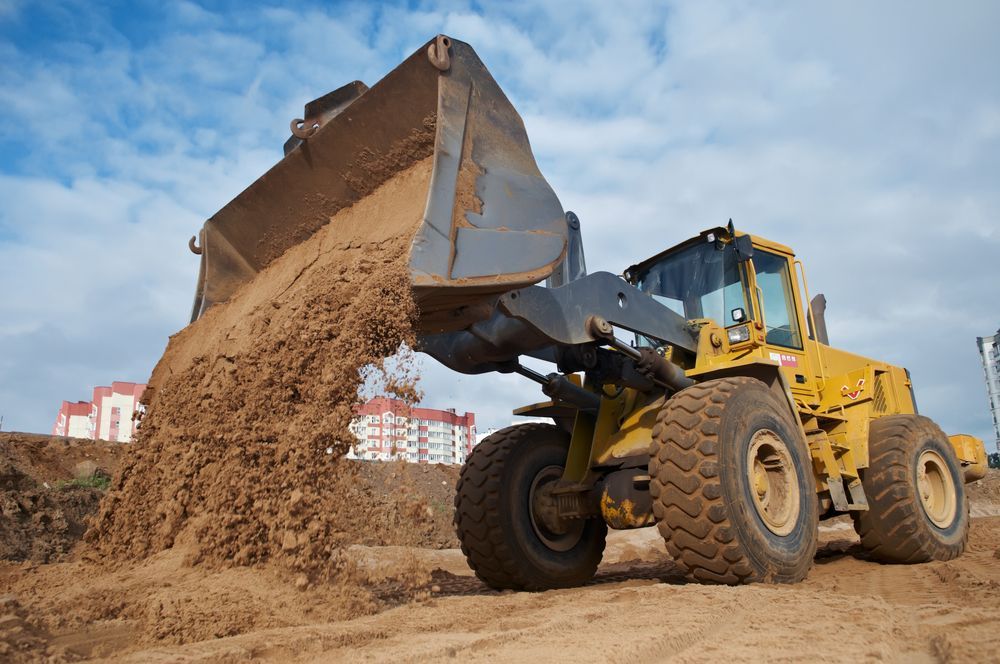 Yellow Loader Dumping Dirt on A Construction Site — Bigfoot Earthmoving In Ballina, NSW