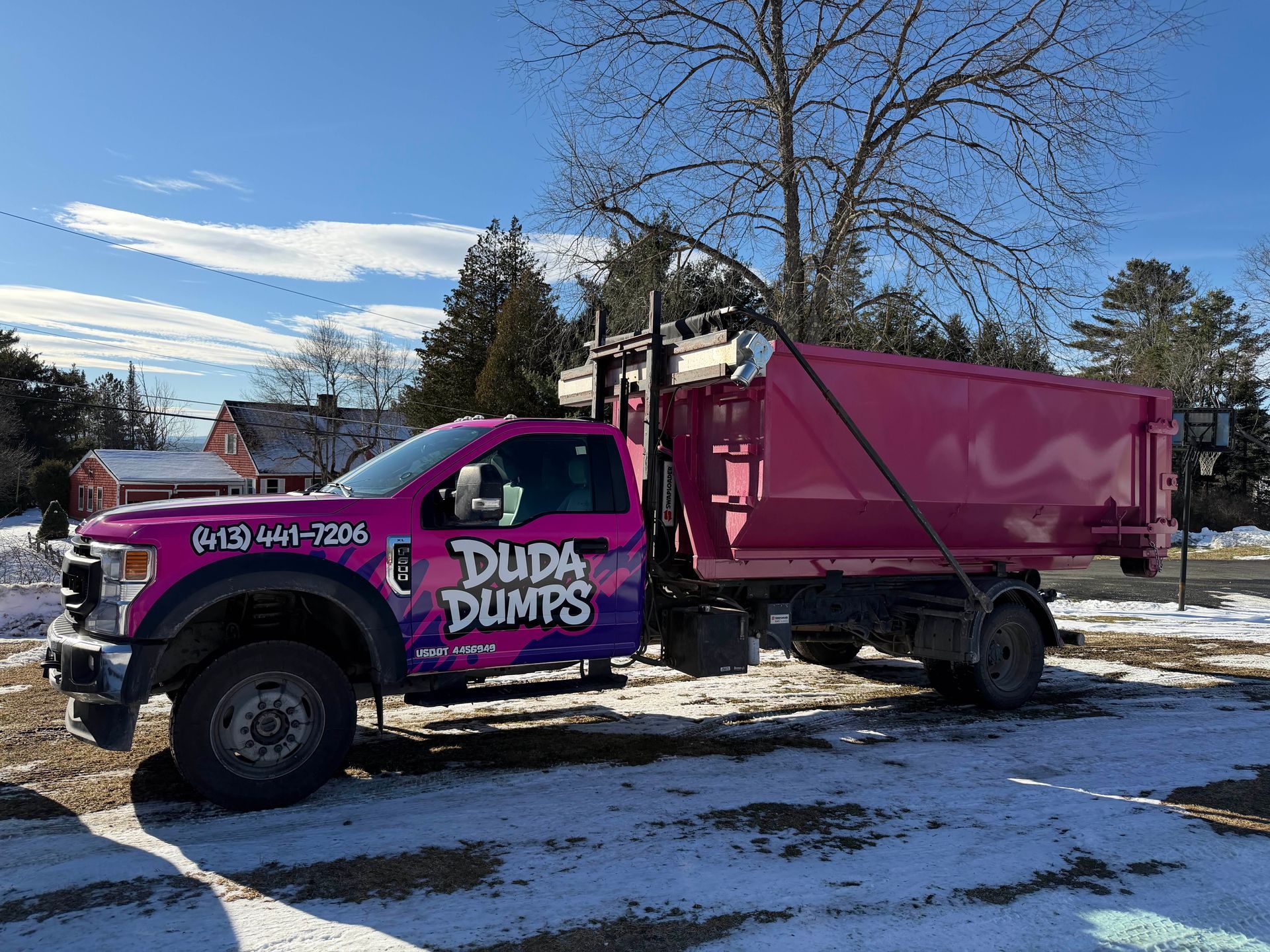 A black trailer full of household debris.
