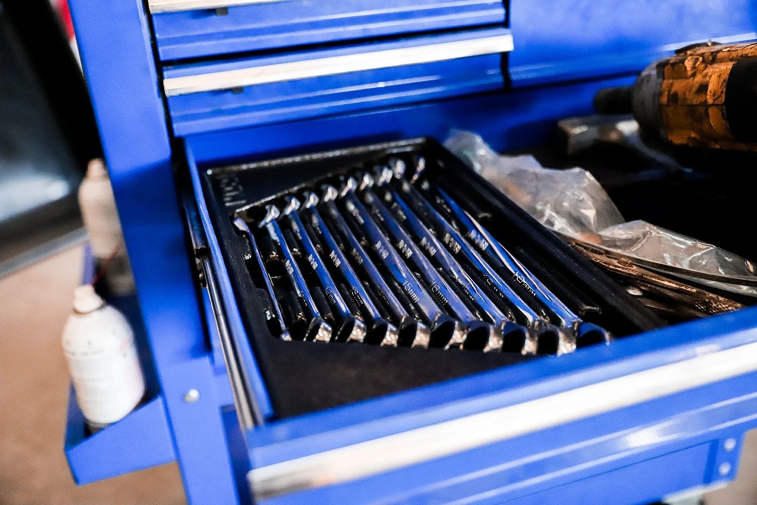Blue toolbox drawer with a set of shiny wrenches in a holder | Kaiser Automotive