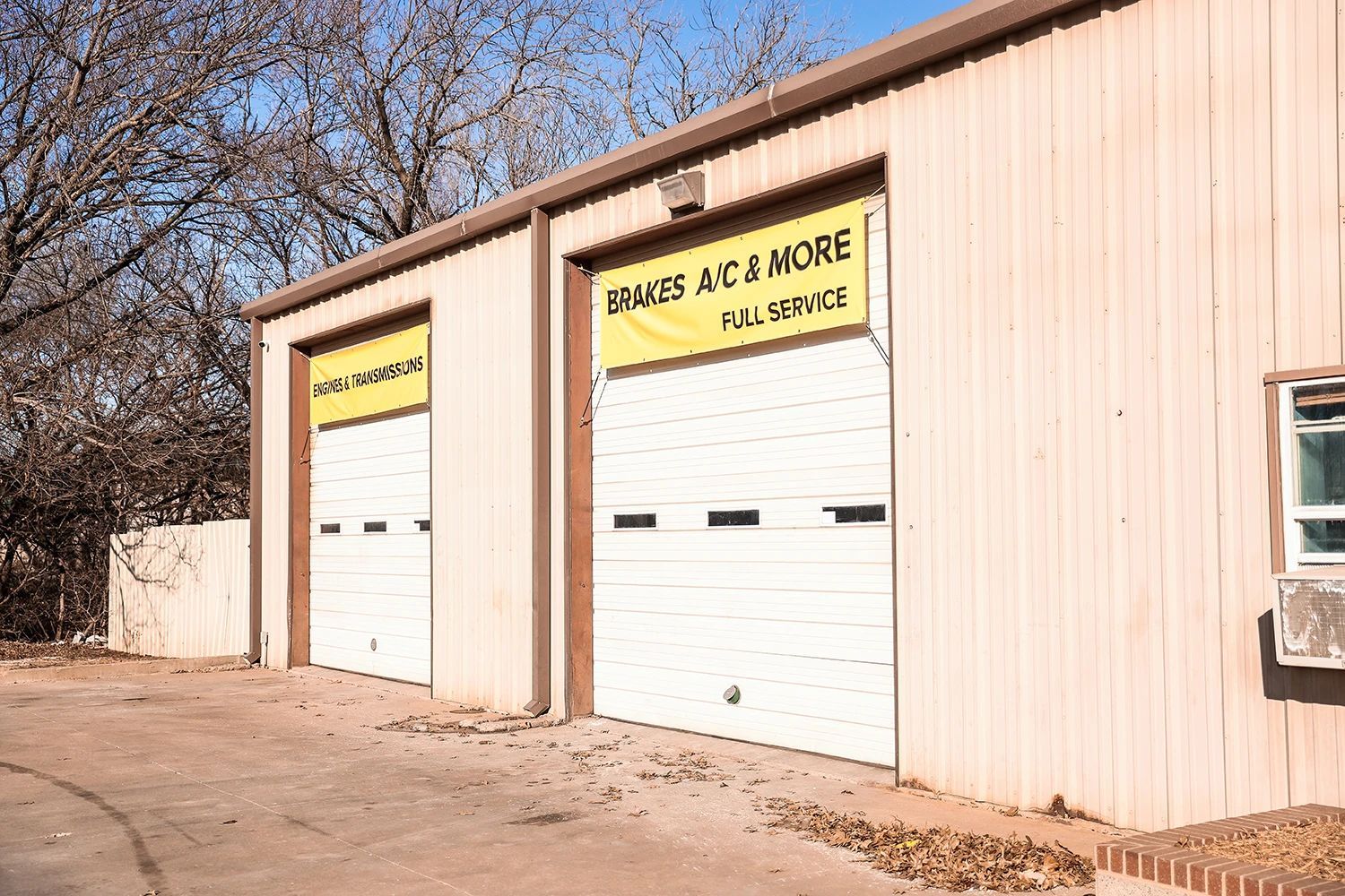 Garage with two bays, one with a sign that reads 