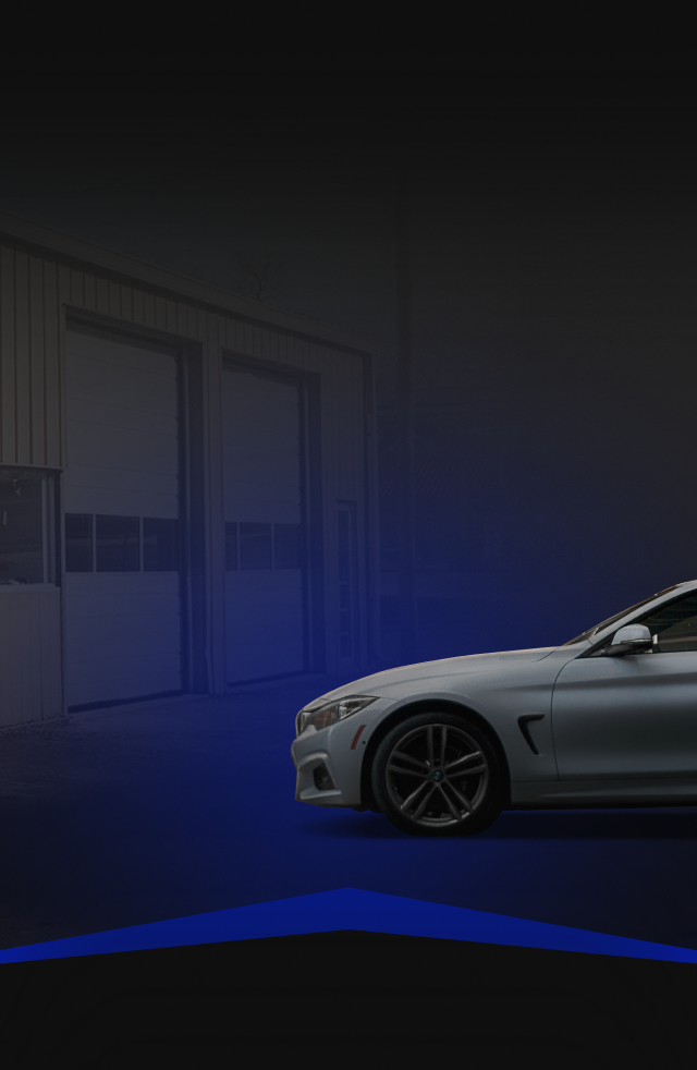 White car parked in front of a garage, with blue gradient lighting.