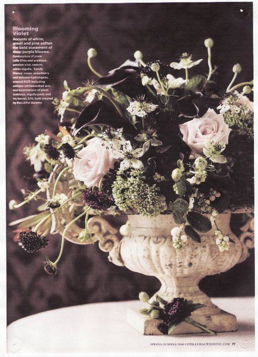 A vase filled with flowers sits on a table - flowers designed by Flowers by Leo