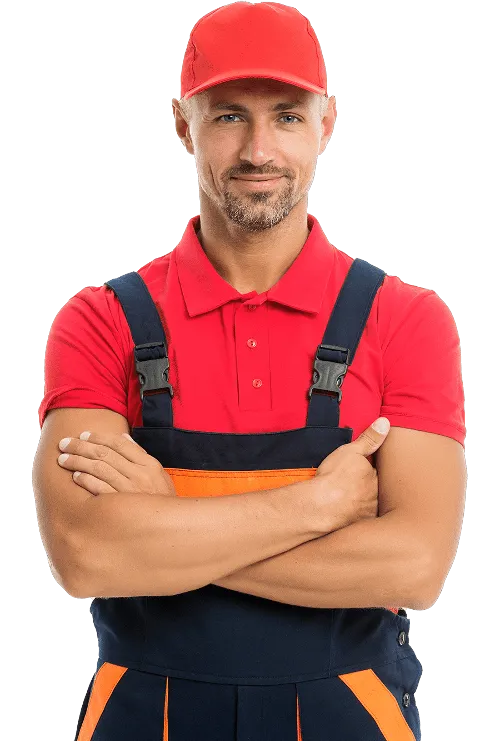 a man in overalls and a red hat is standing with his arms crossed .