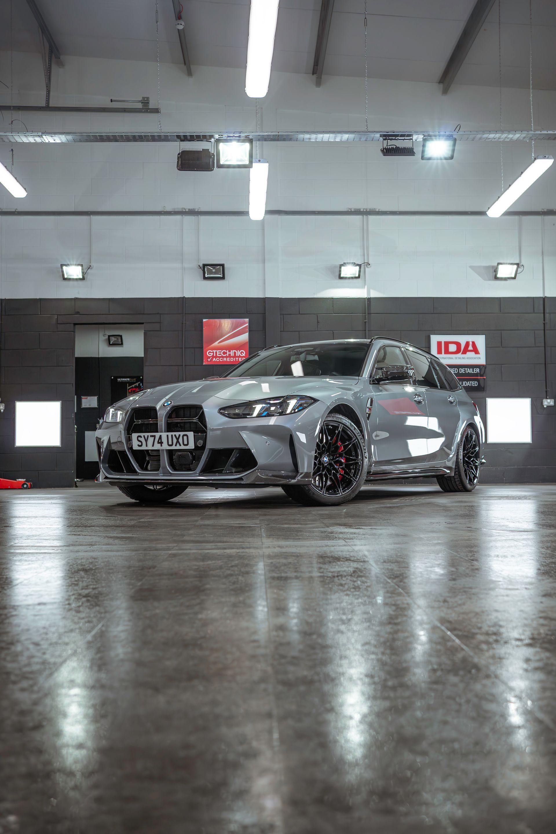 A bmw m4 is parked in a garage.