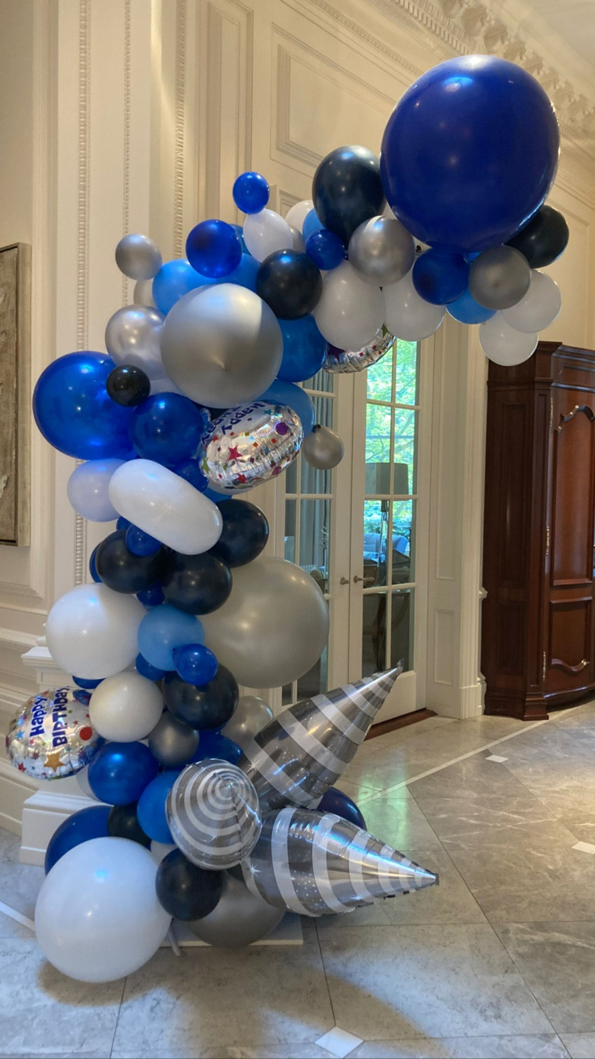 A bunch of balloons are sitting on the floor in a room.