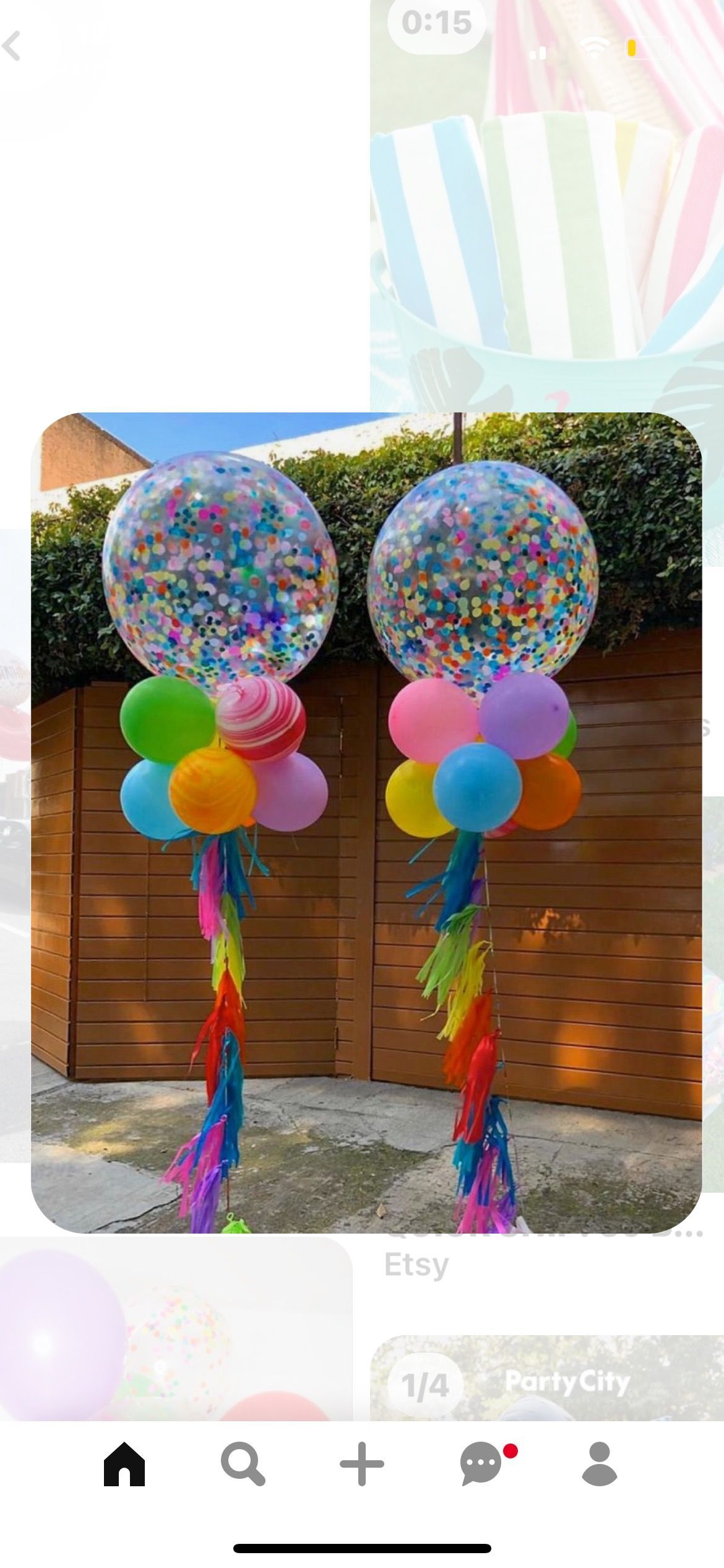 A couple of balloons sitting on top of each other in front of a wooden building.