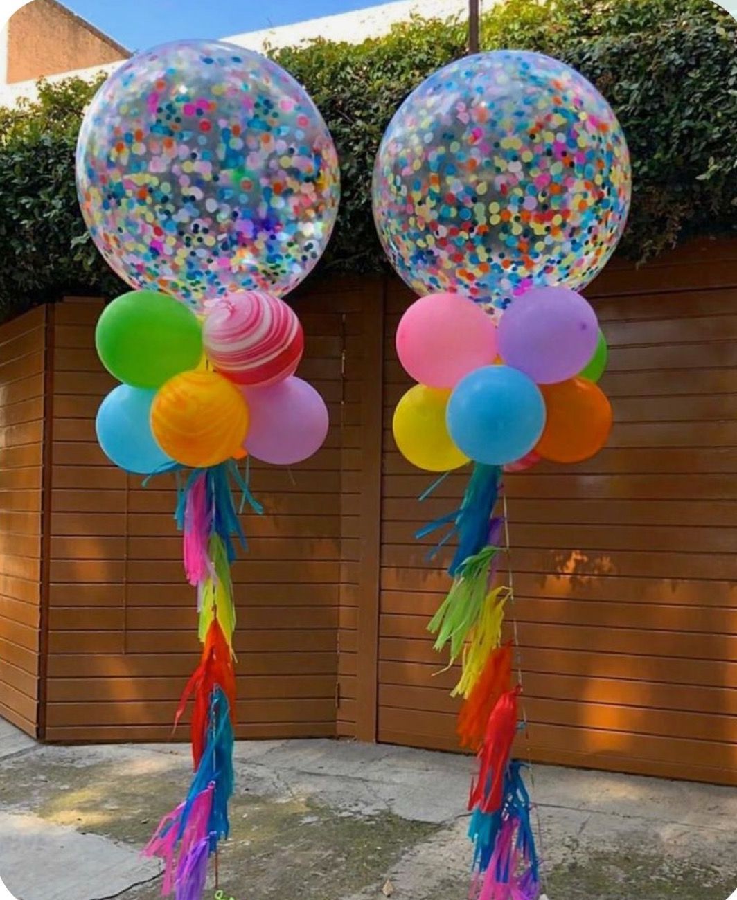 A couple of balloons sitting on top of each other in front of a wooden building.