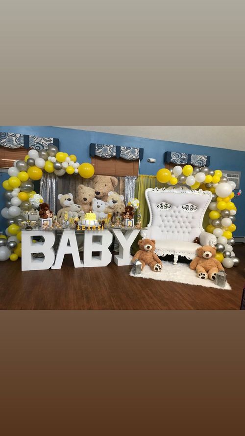 A room decorated for a baby shower with teddy bears and balloons.
