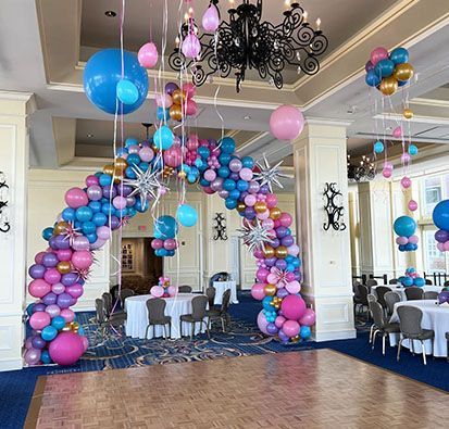 A room filled with balloons and tables and chairs