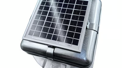 A solar panel is sitting on top of a metal box.