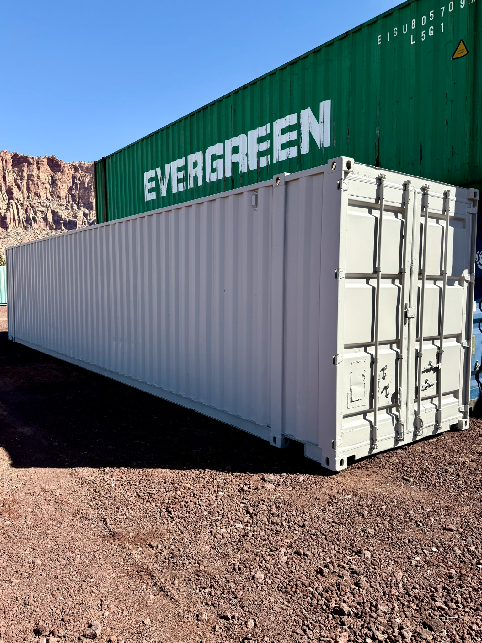 A green and white shipping container with the word evergreen on it