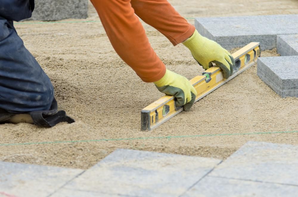A Construction Worker Is Using a Level to Level the Ground — S & L Sand & Gravel in South Lismore, NSW
