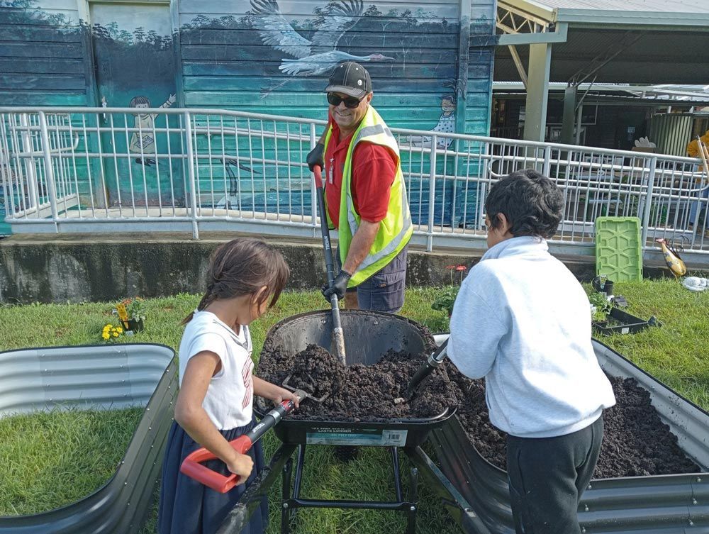 Shoveling Landscape Supplies Outside Residential House