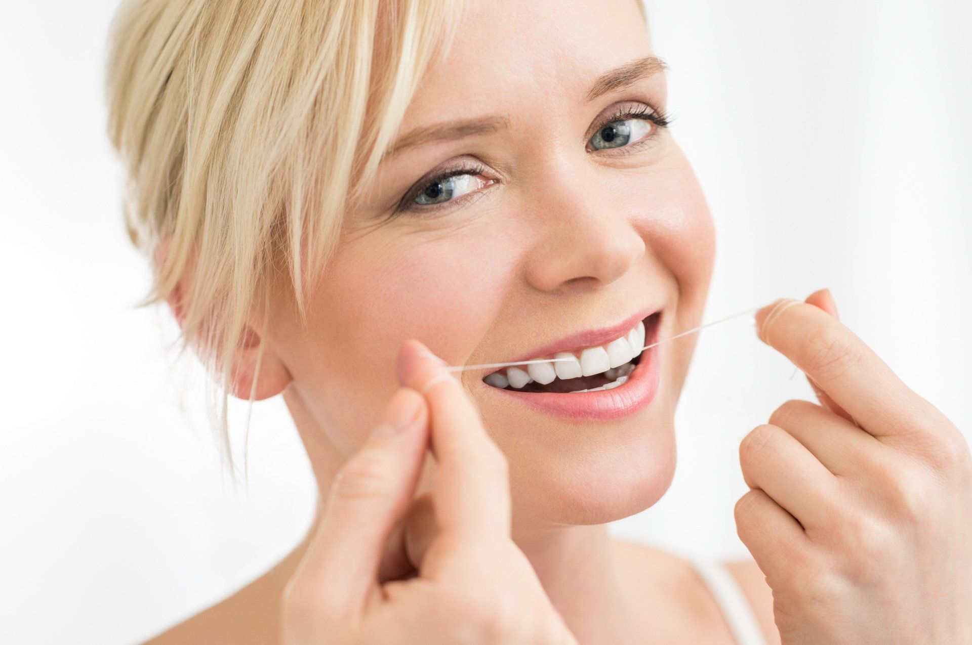 Woman flossing her teeth — Ashland and Ruther Glen, VA — Ashland Family Dentistry