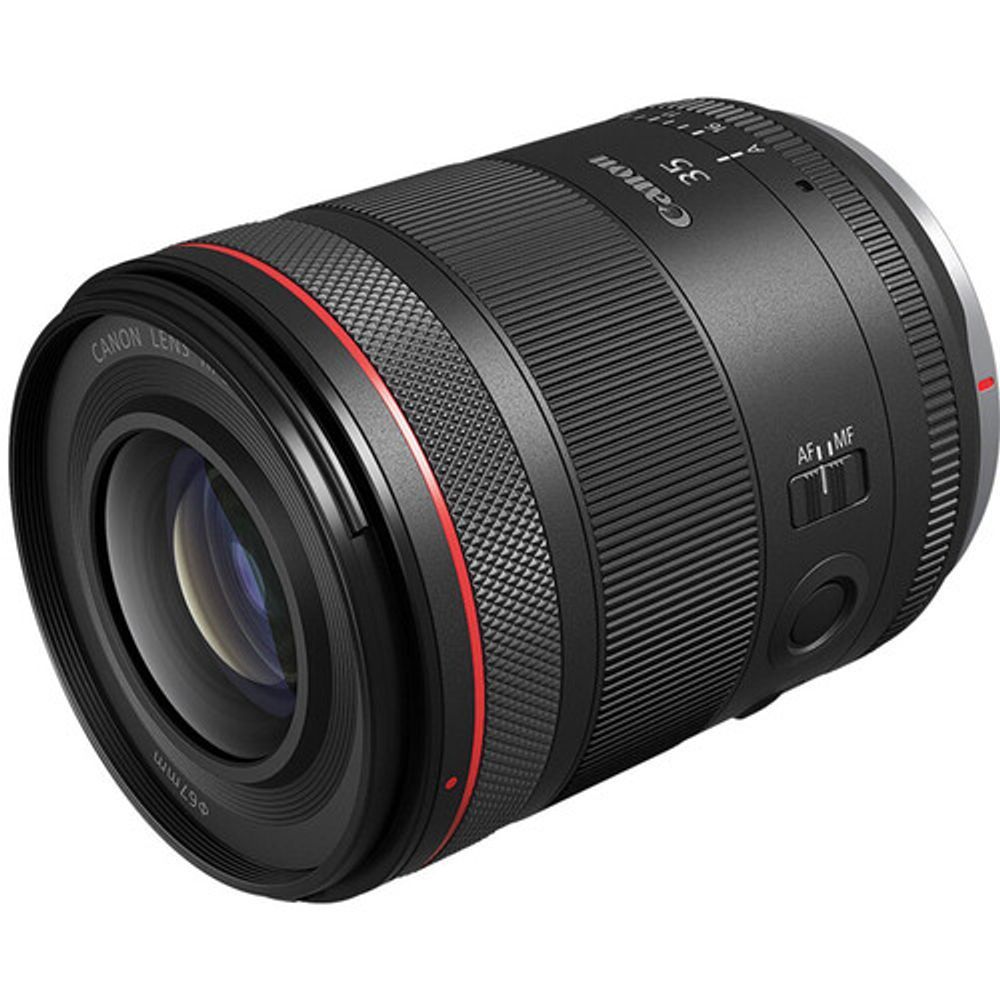 Black Canon camera lens with red ring, angled on a white background