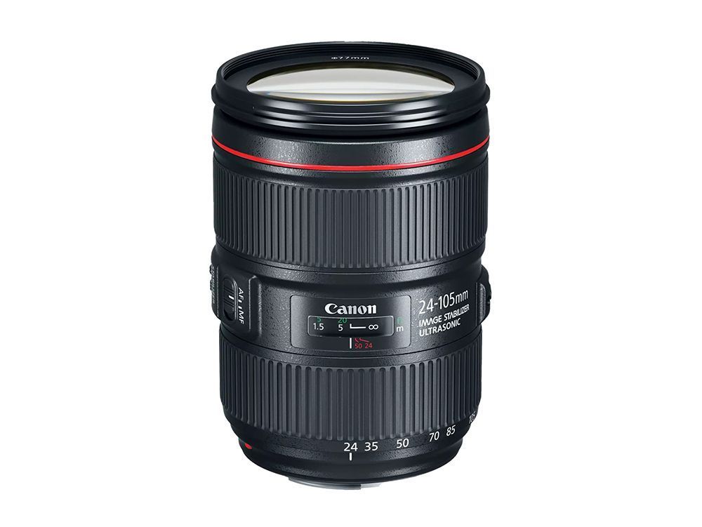 Black Canon camera lens with red ring, standing upright on a white background