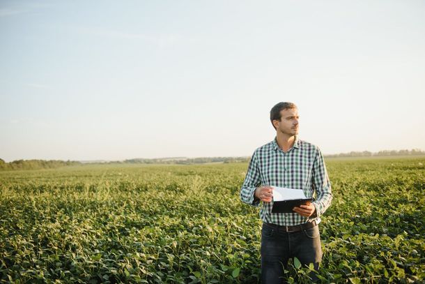 Tow truck with two damaged vehicles, a red SUV and a white sedan, at a traffic intersection.