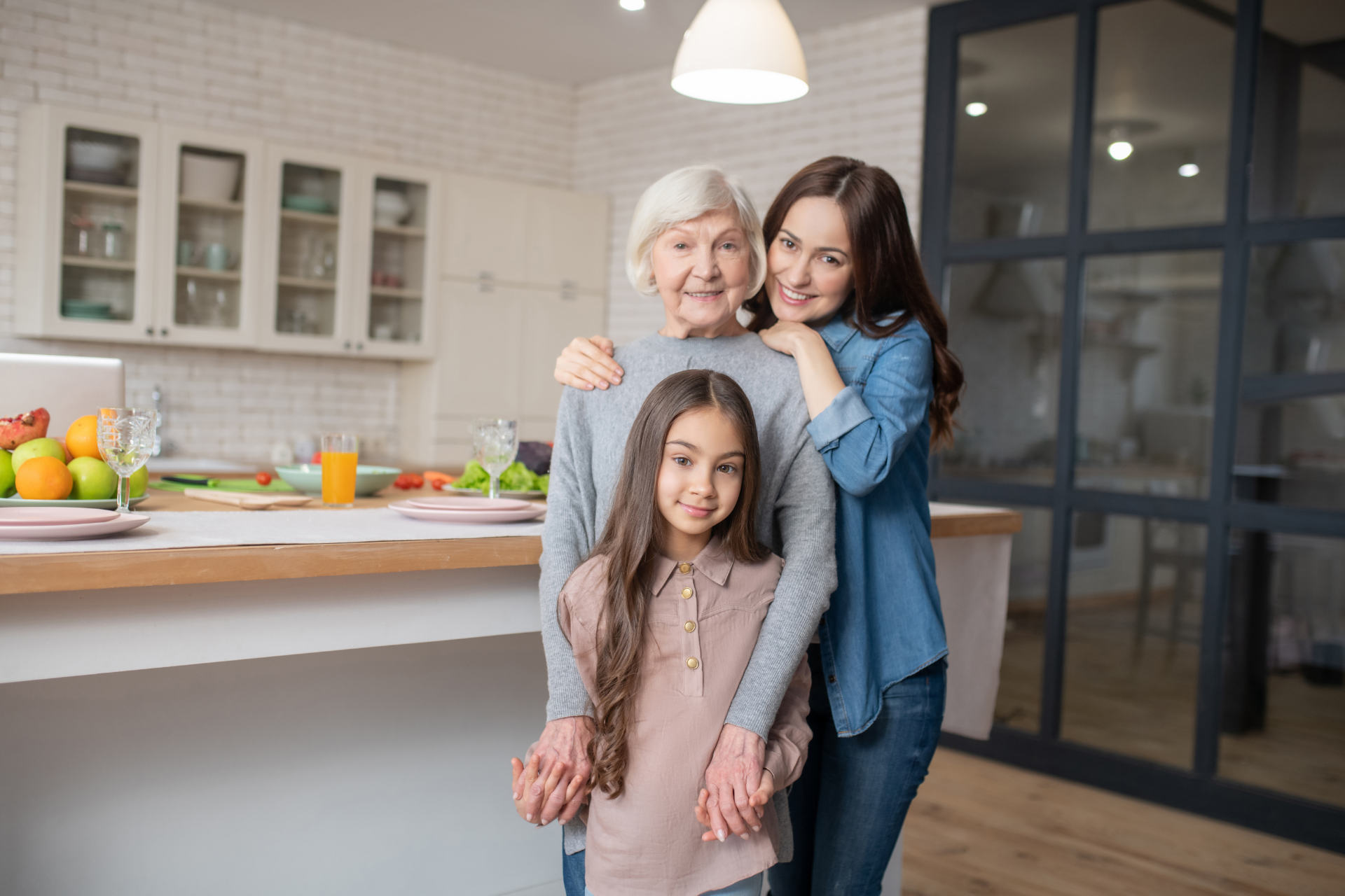Woman holding a smartphone with multiple app icons, indoors near a TV.