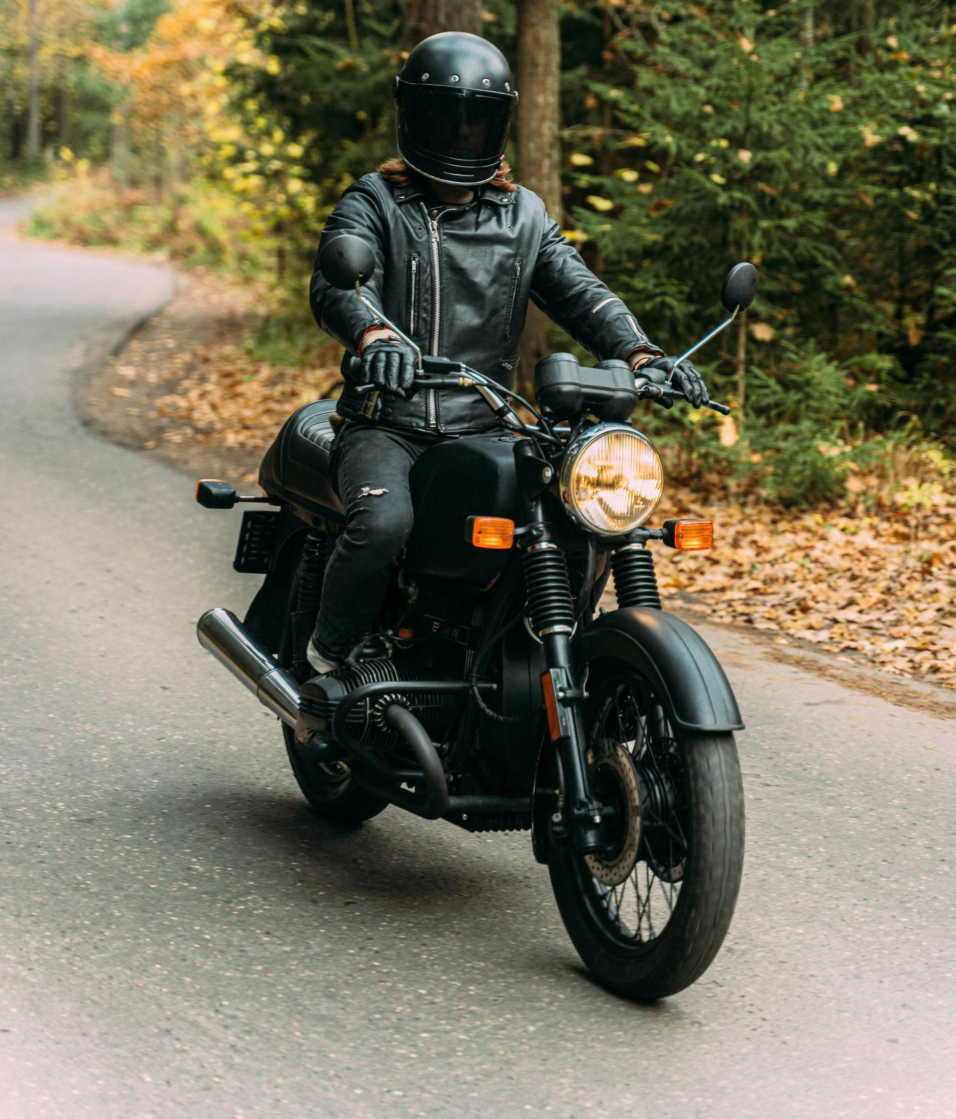 A family is sitting on the porch of their house next to a swimming pool.