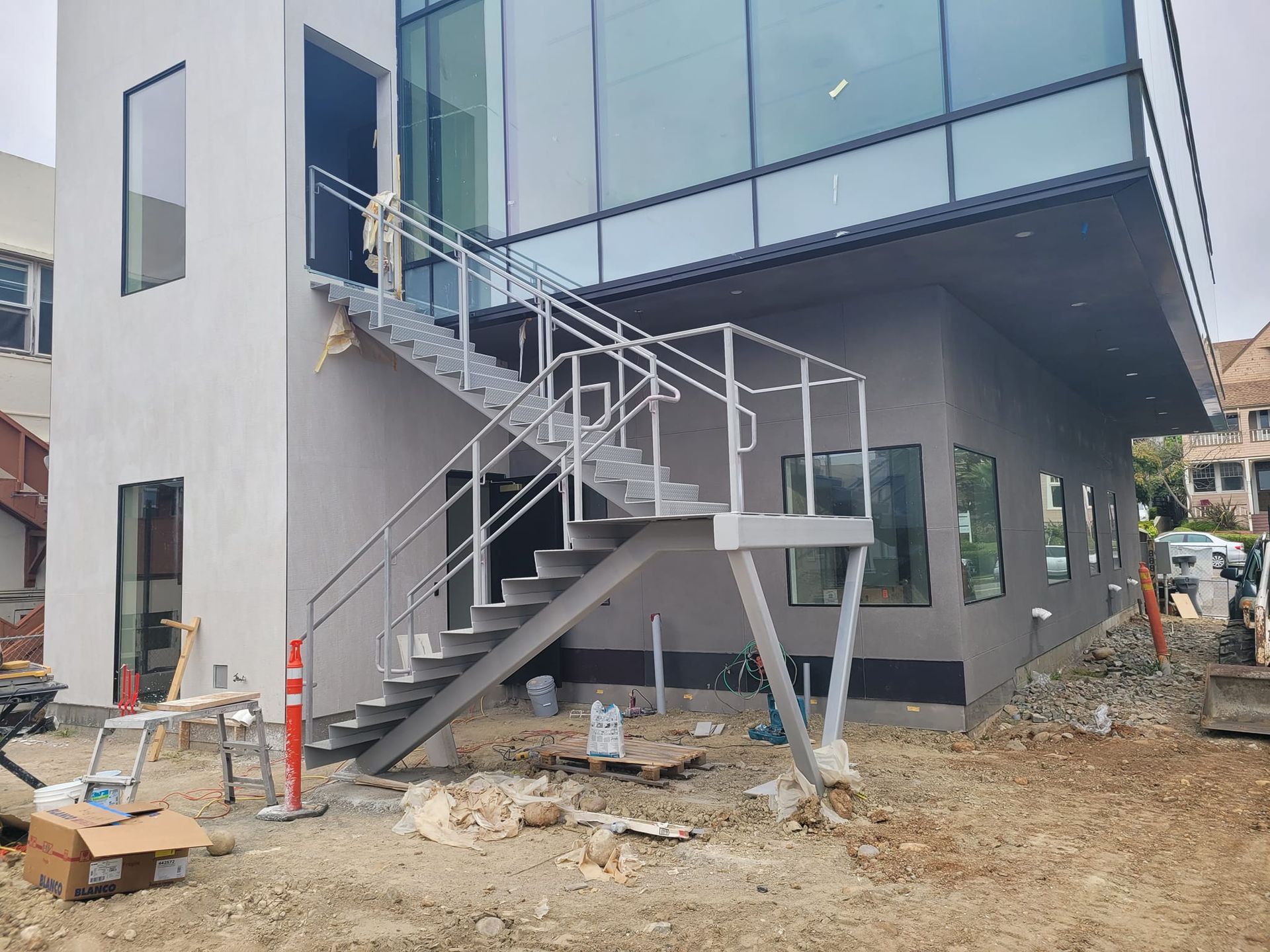 A building under construction with stairs leading up to it.