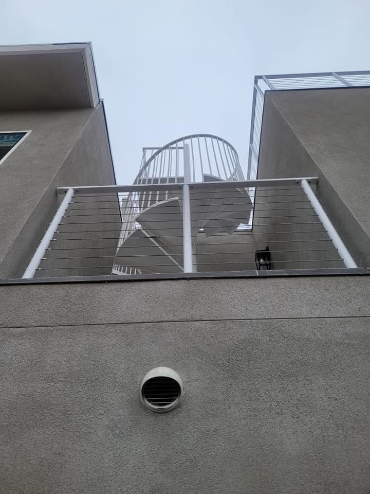 A building with a balcony and stairs on it