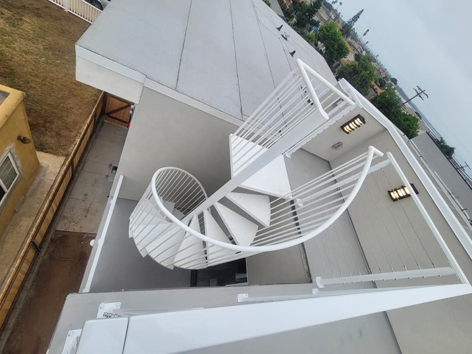 An aerial view of a spiral staircase on the side of a building