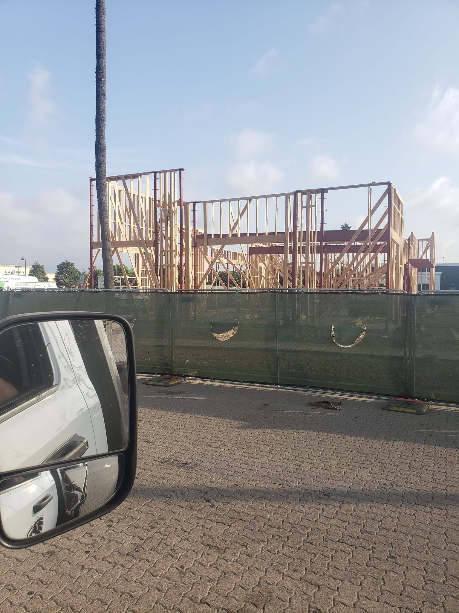 A truck is parked in front of a building under construction