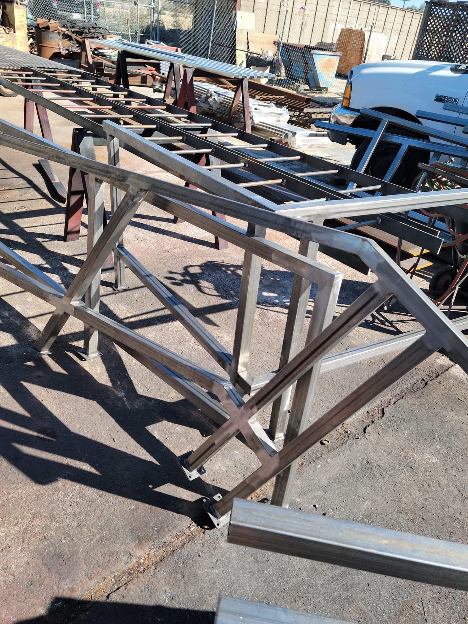 A large metal structure is sitting on top of a concrete surface.