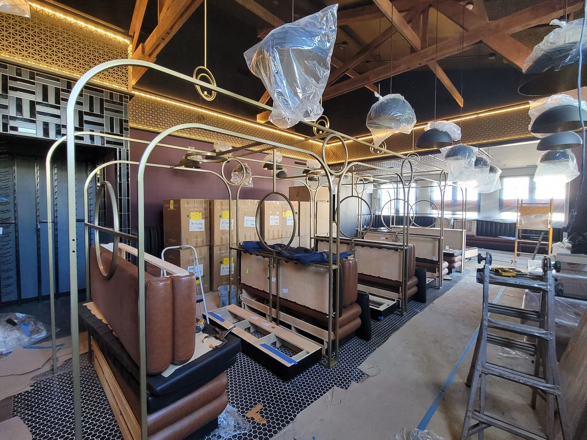 A large room with a lot of furniture and boxes on the floor.