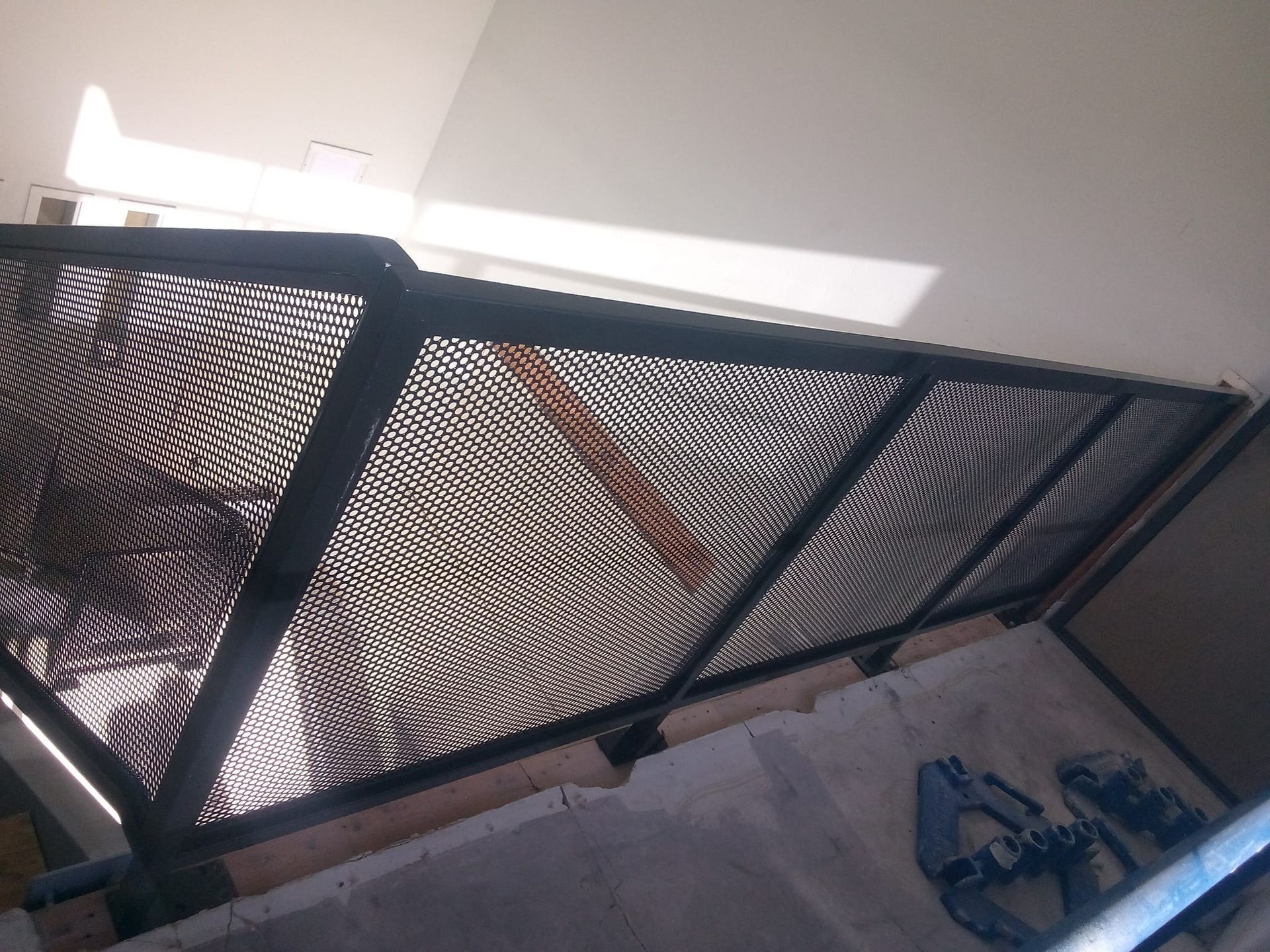 A staircase with a metal railing going up to the second floor.