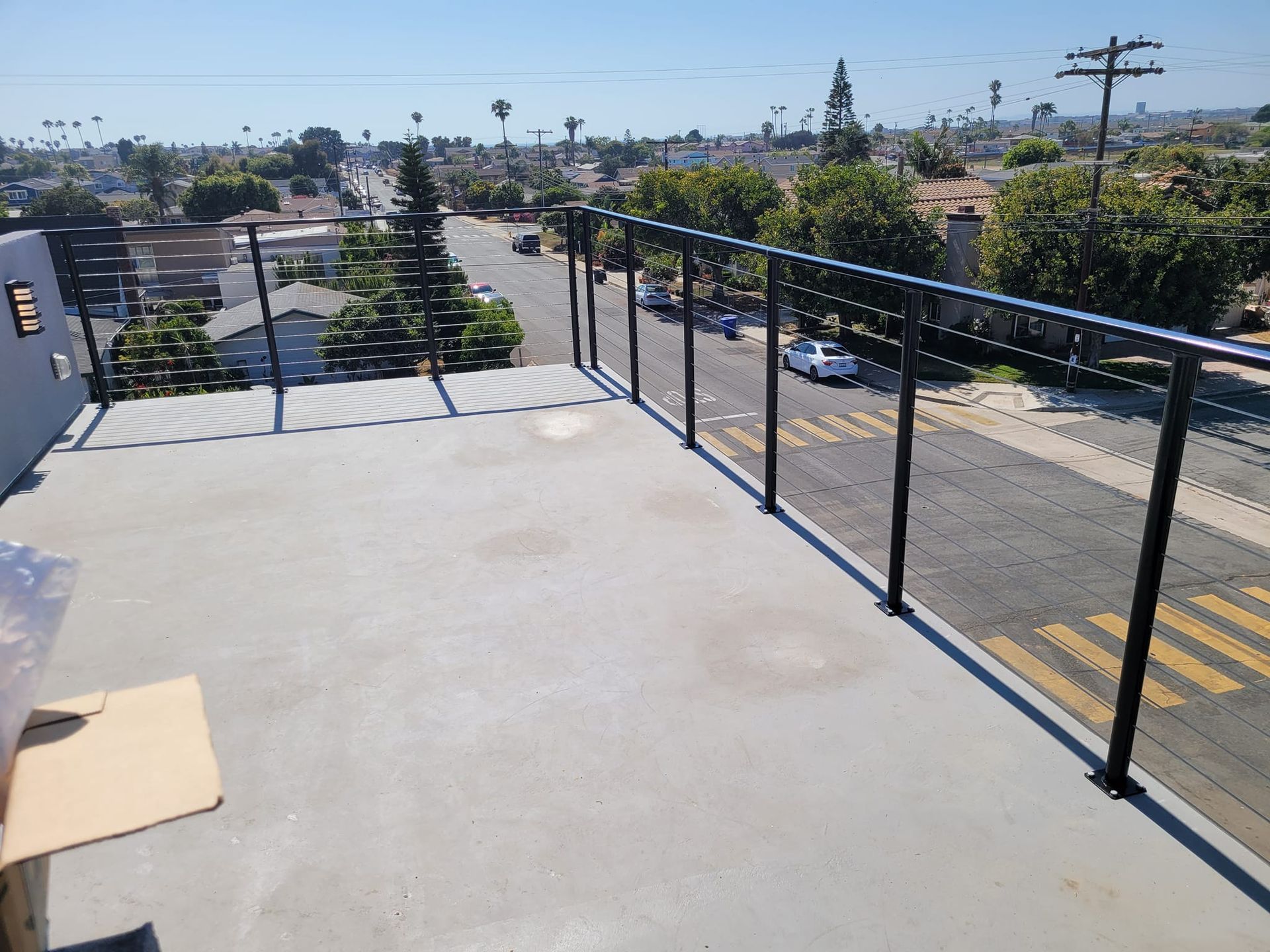 A balcony with a railing overlooking a city street