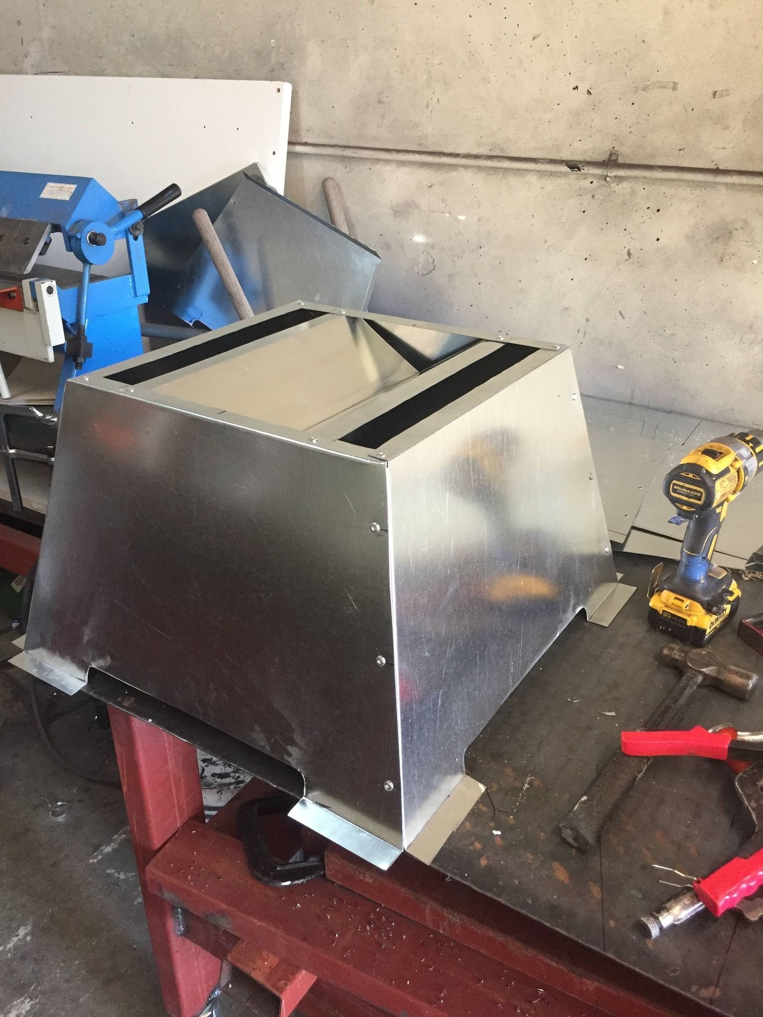 A metal box is sitting on top of a wooden table.