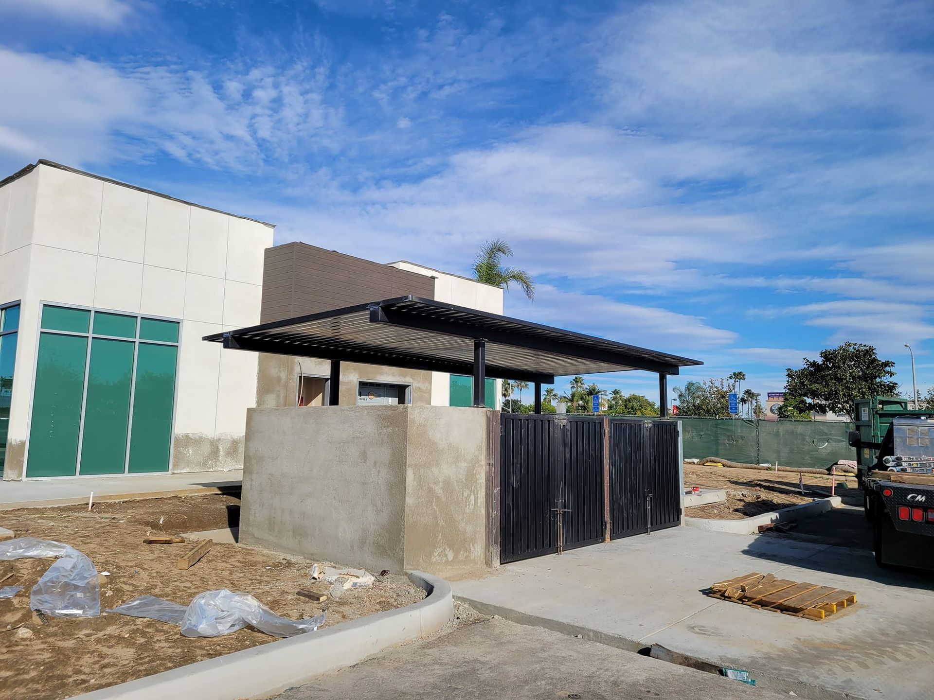 A building under construction with a fence in front of it.