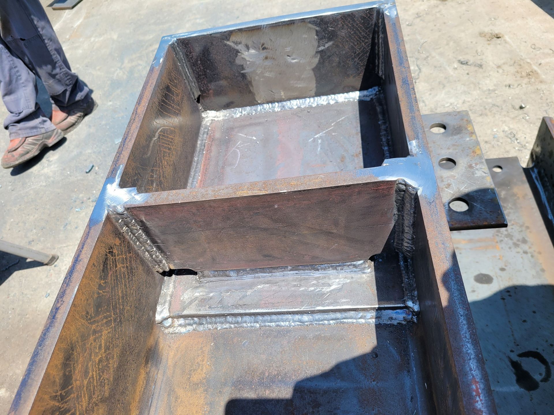 A large piece of metal is sitting on the ground.