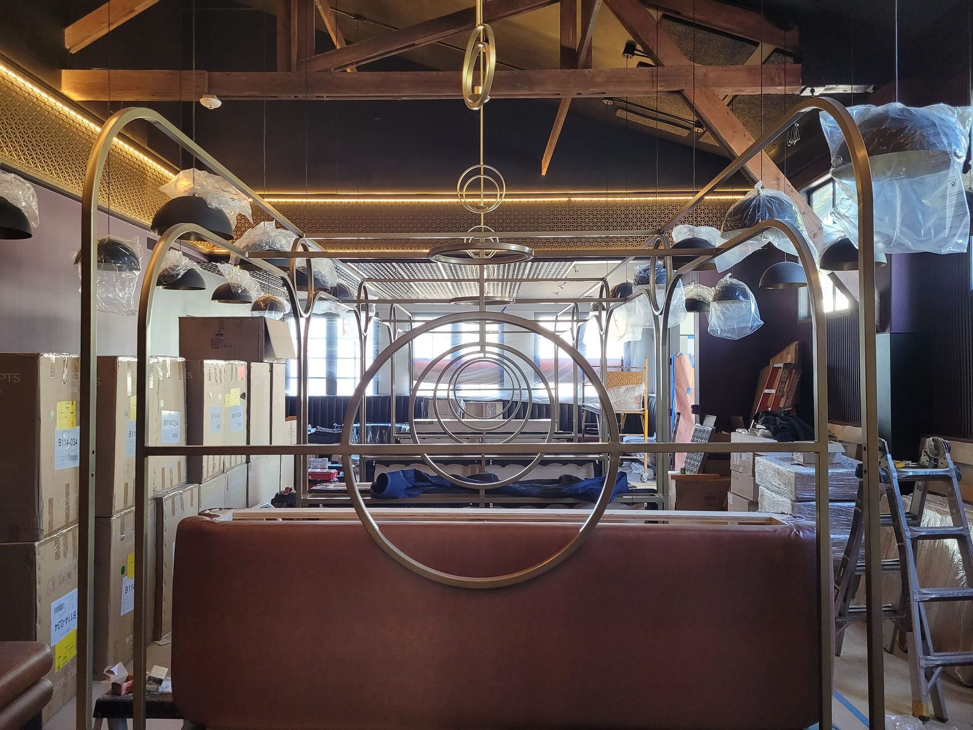 A large room with a couch and a chandelier hanging from the ceiling.