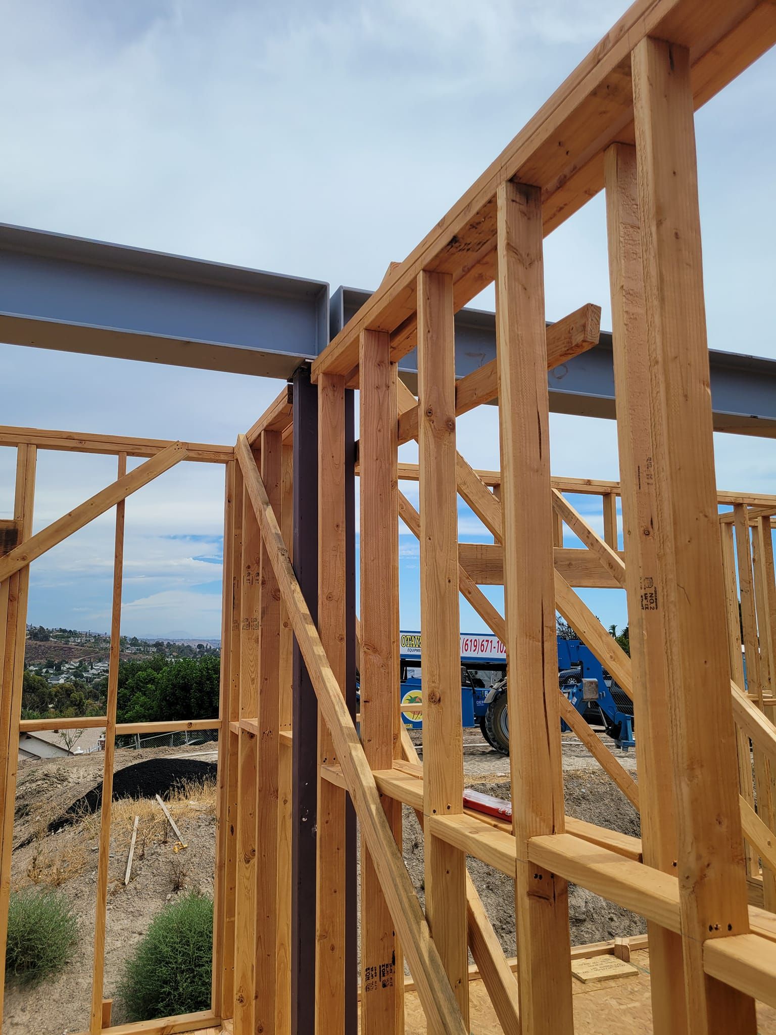 A building is being built with wooden beams and steel beams.