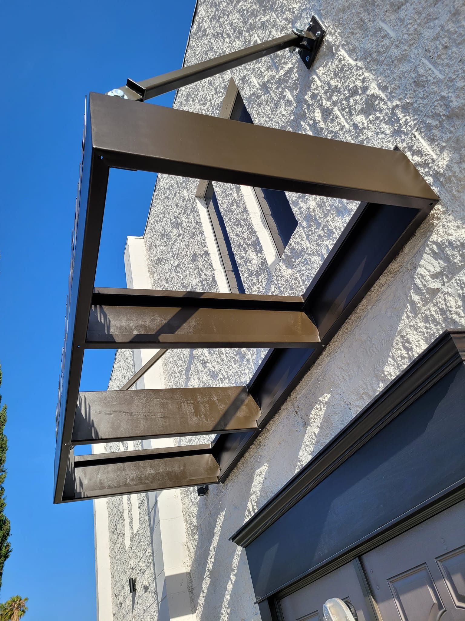 A canopy is attached to the side of a building