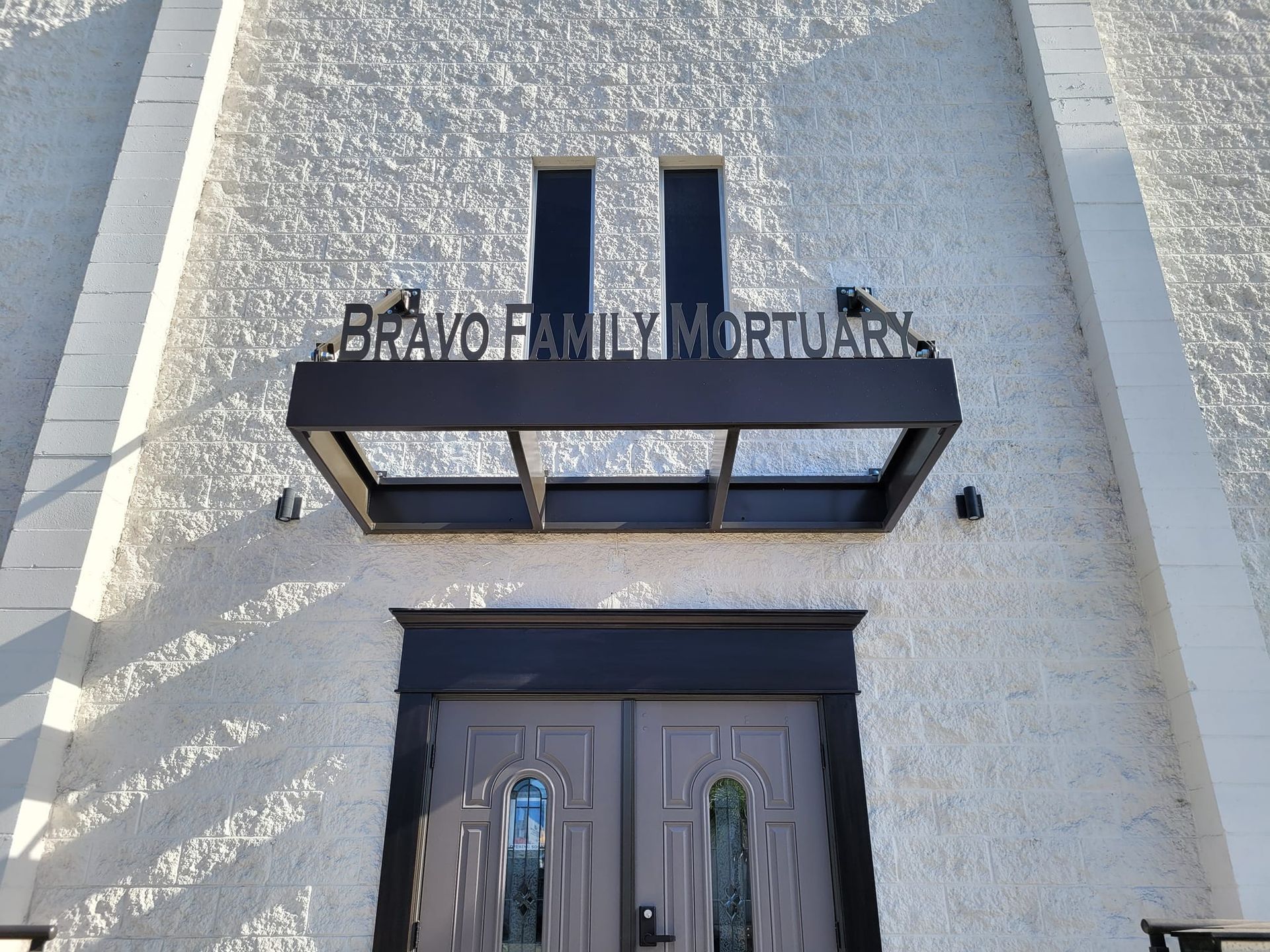 A building with a sign that says bravo family mortuary