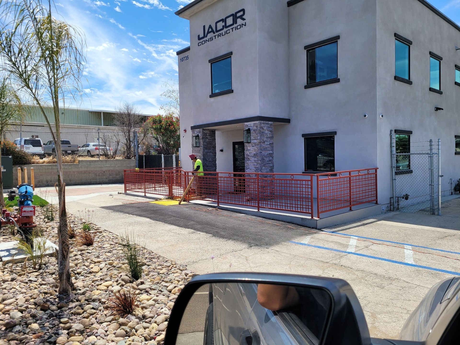 A car is parked in front of a building that says yacor on it.