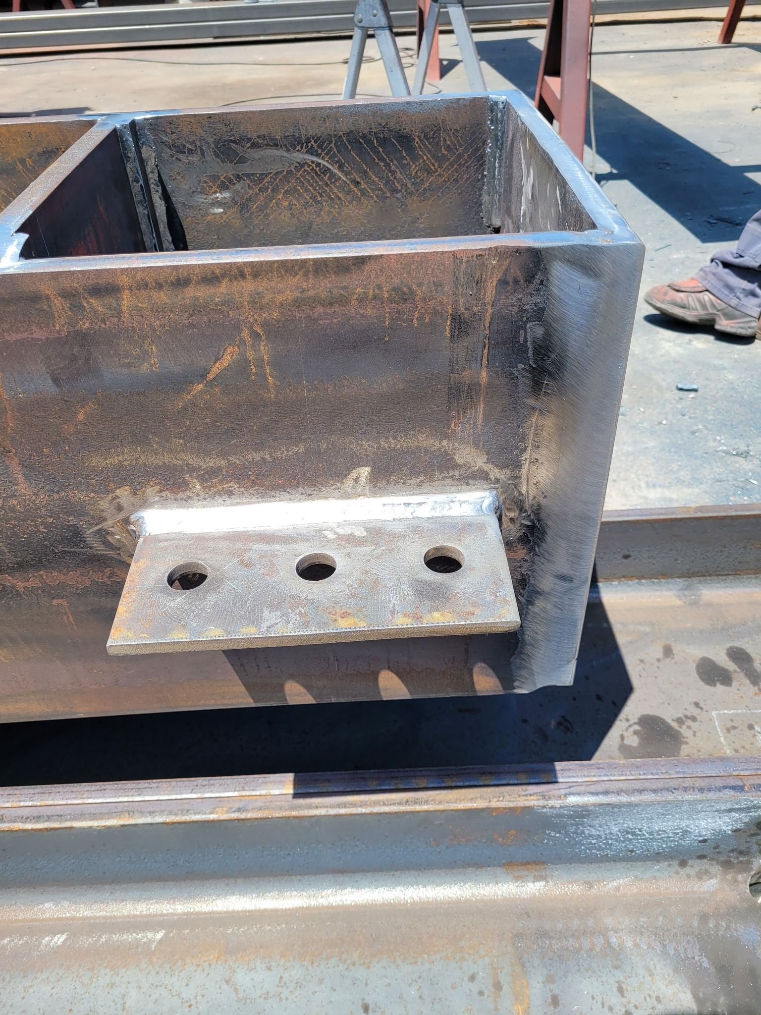 A piece of metal with holes in it is sitting on a table.