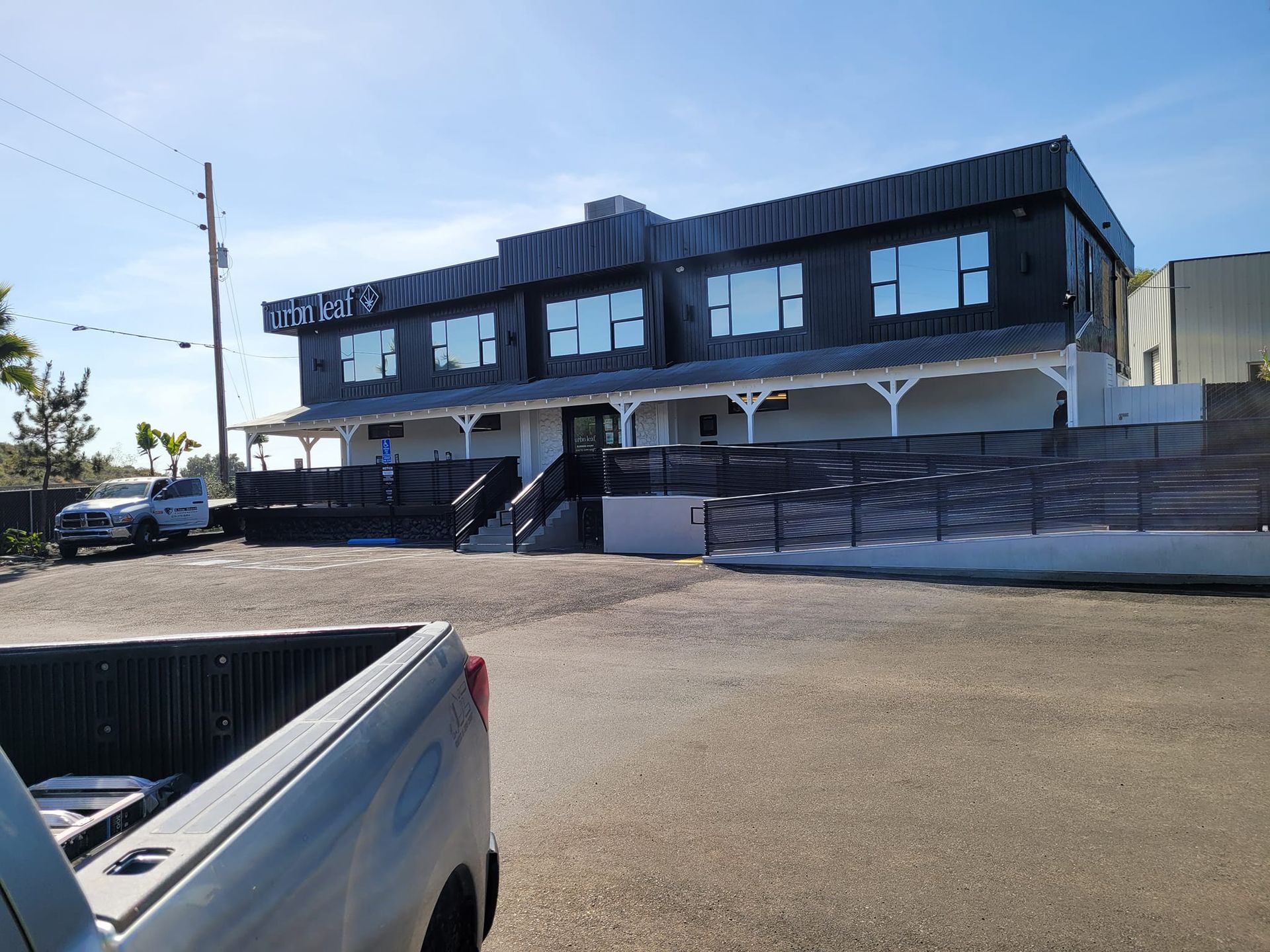 A truck is parked in front of a large building.